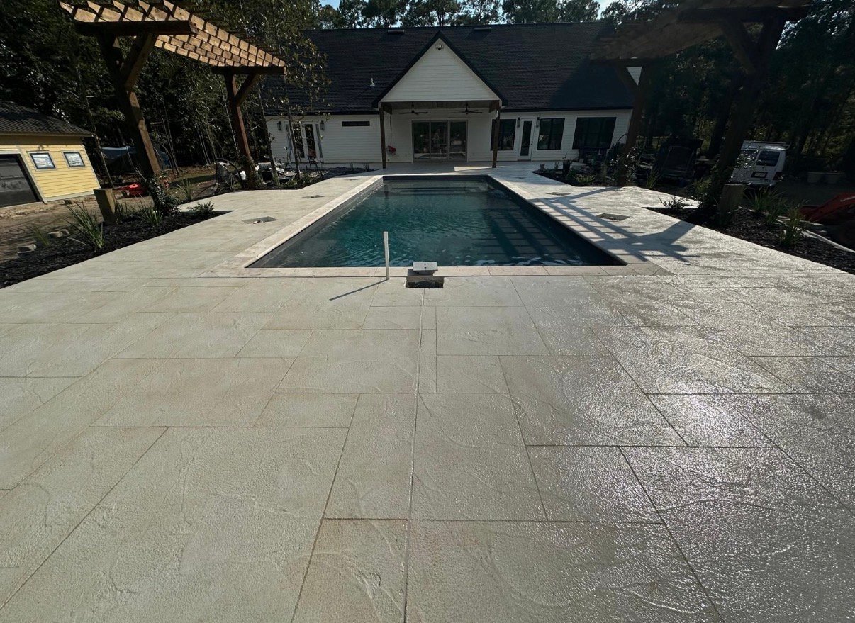 Decorative pool deck resurfacing finish for a residential outdoor space