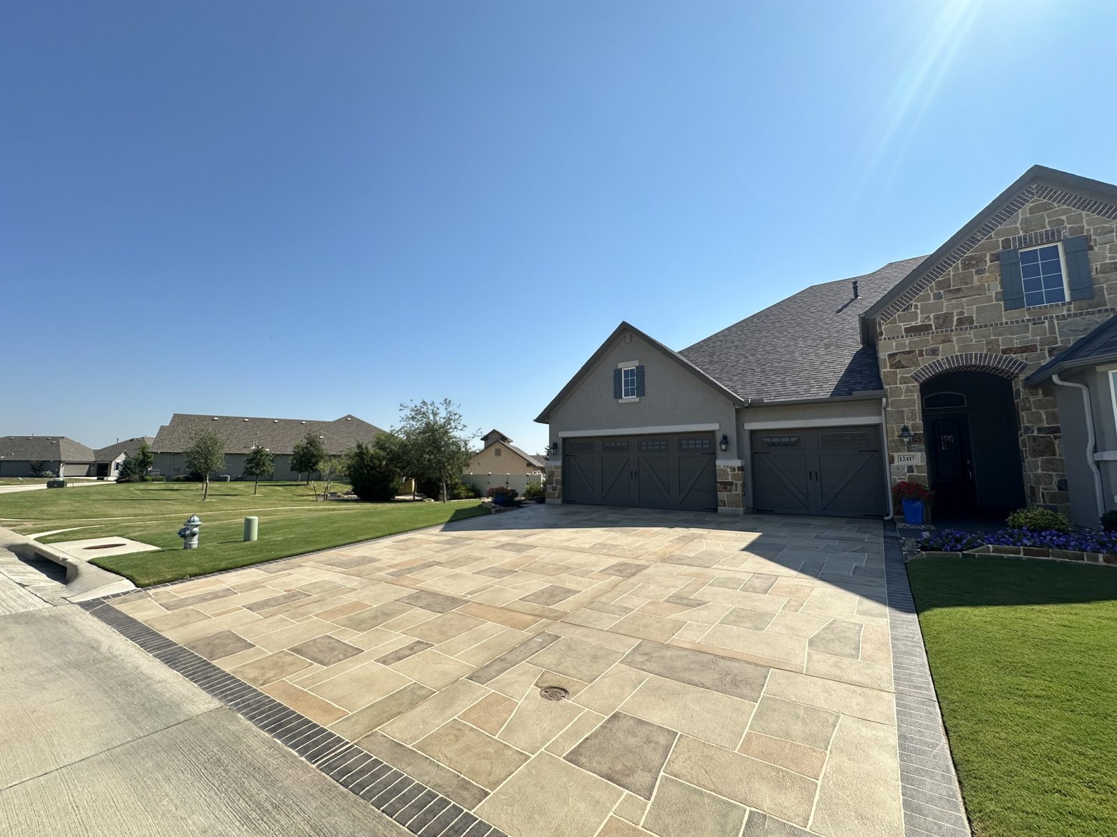 Decorative concrete overlay and resurfacing finish for a driveway